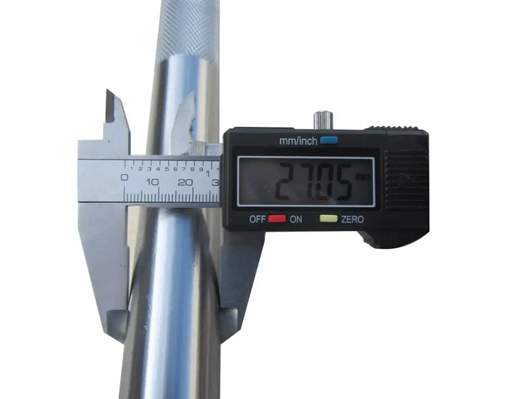 Caliper measuring diameter of StrongArm Conventional Deadlift Bar, showcasing precision for serious weightlifting in Canada.