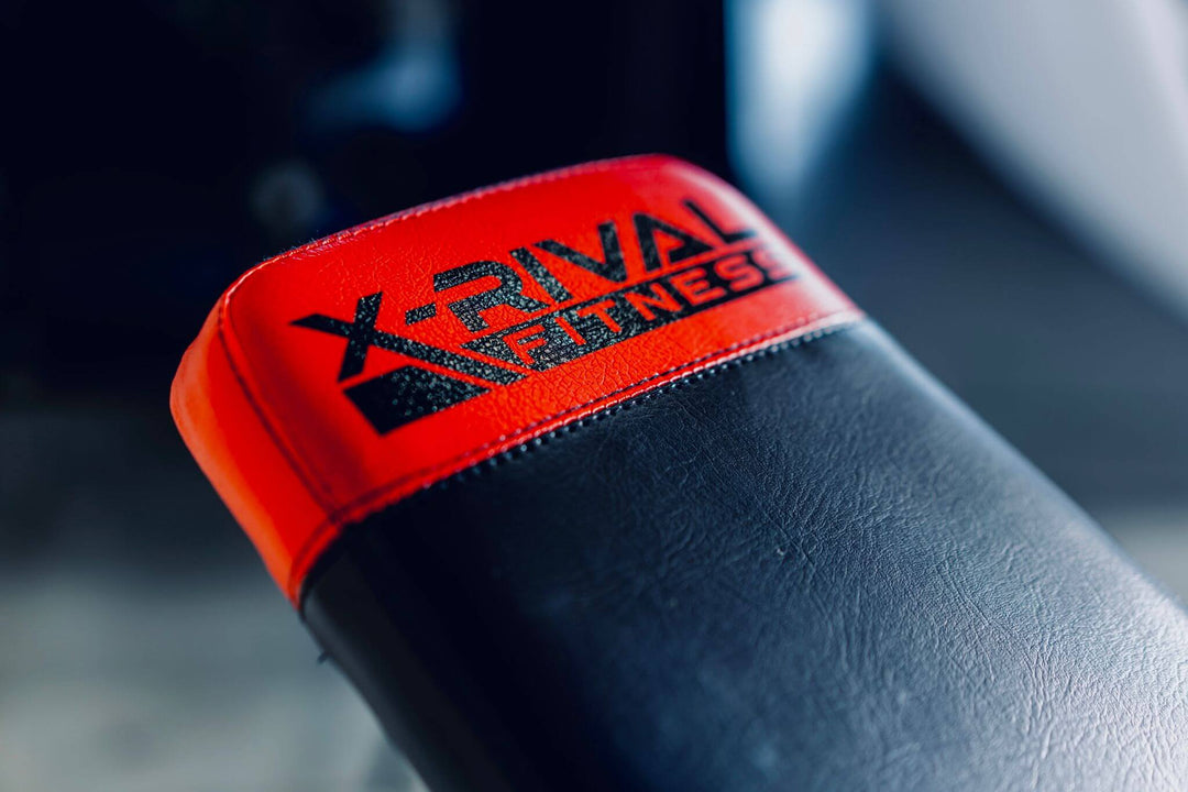 Close-up of X-RIVAL Fitness adjustable bench with vibrant red and black design, perfect for diverse workouts.