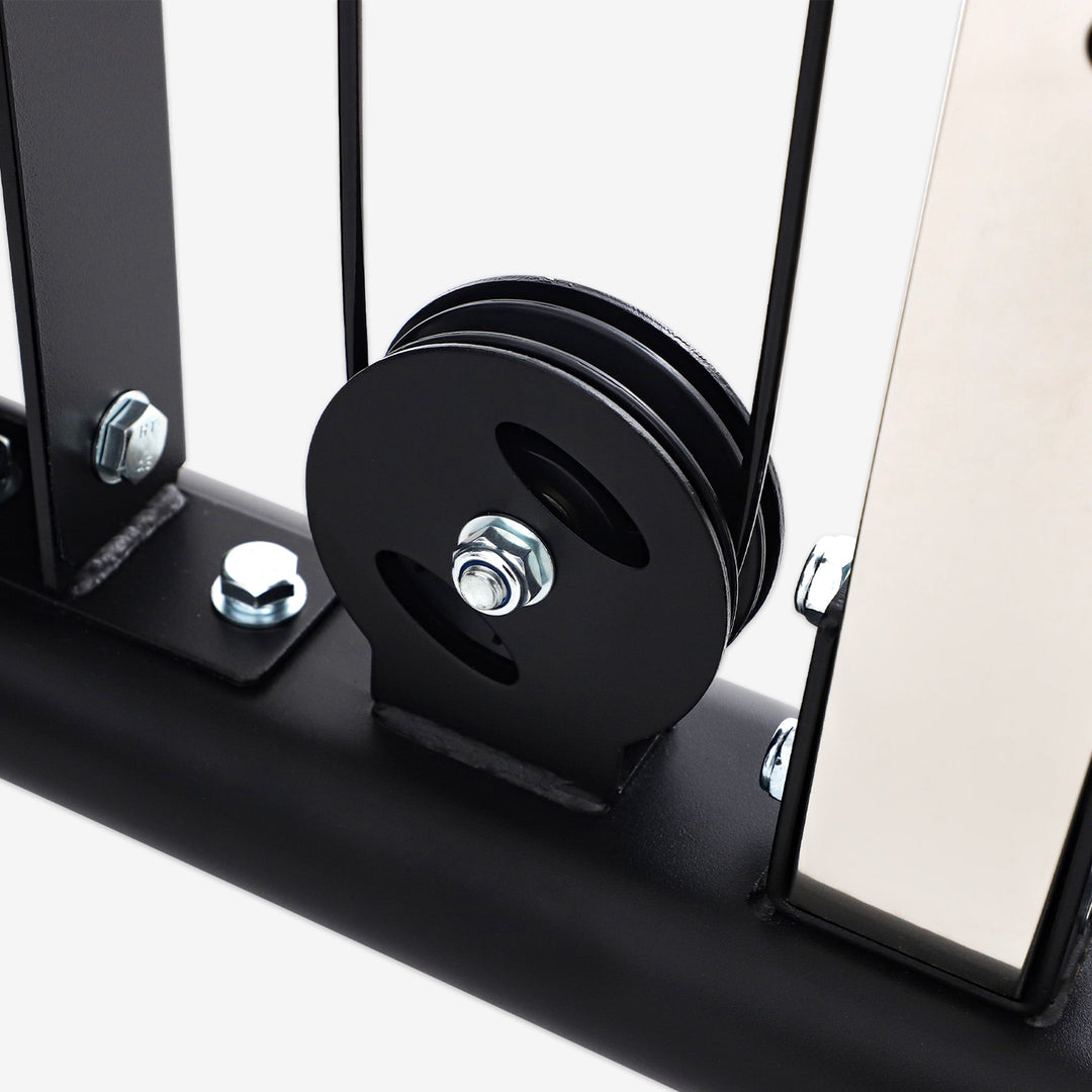 Close-up of a black pulley system on a white background