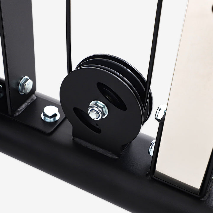 Close-up of a black pulley system on a white background