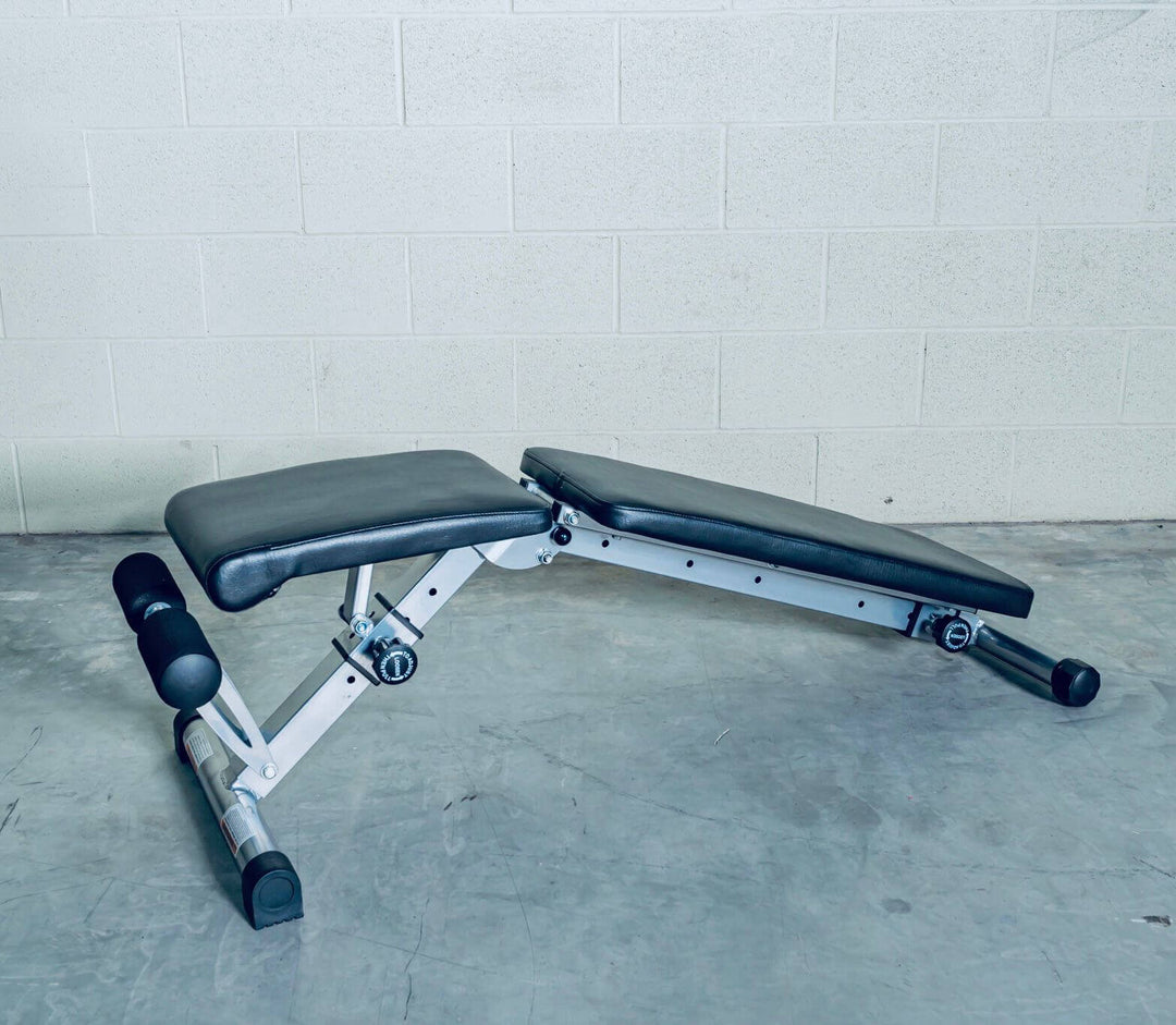 Adjustable workout bench for strength training in a home gym, ideal for various exercises.