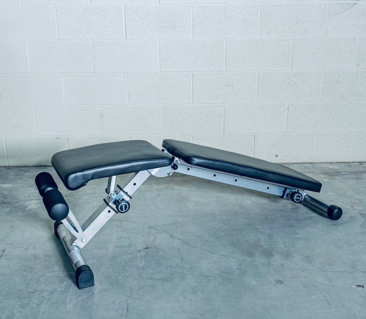 Adjustable workout bench for strength training in a home gym, ideal for various exercises.