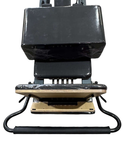 Pilates Reformer M apparatus for strength training, featuring adjustable springs and smooth sliding carriage.