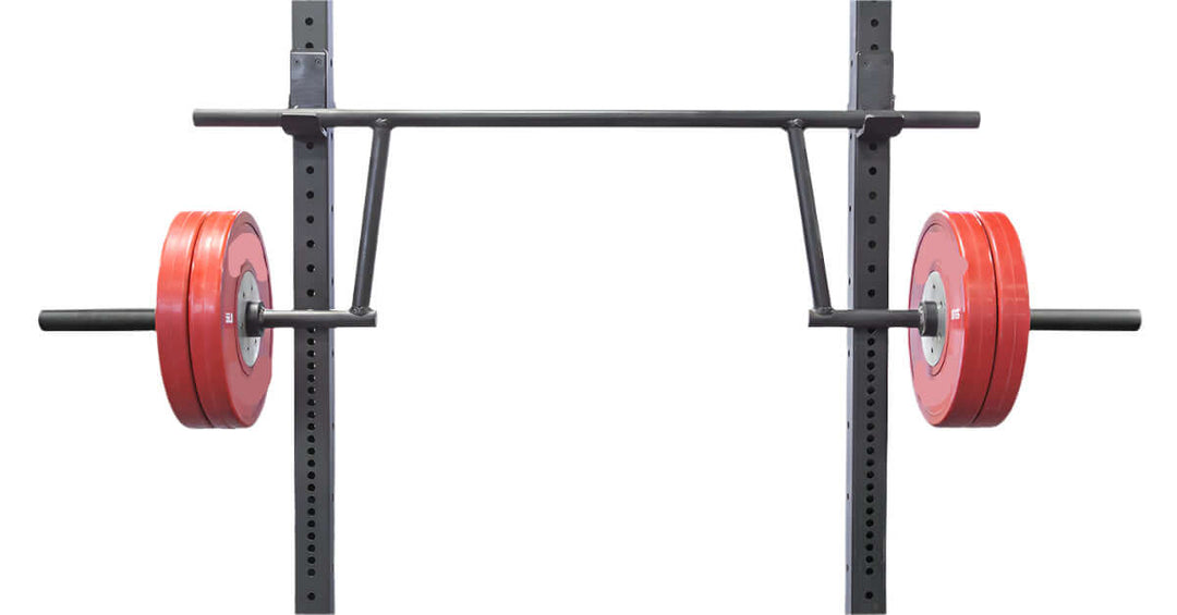 StrongArm Camber Bar with red bumper plates on a power rack, ideal for strength training in Calgary gyms.