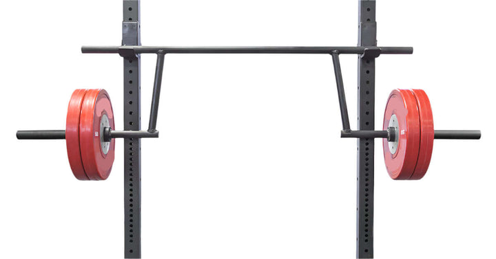 StrongArm Camber Bar with red bumper plates on a power rack, ideal for strength training in Calgary gyms.