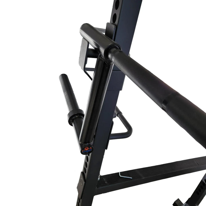 StrongArm Camber Bar in a squat rack, featuring a knurled grip and fixed sleeves, ideal for strength training. Gym equipment Calgary.