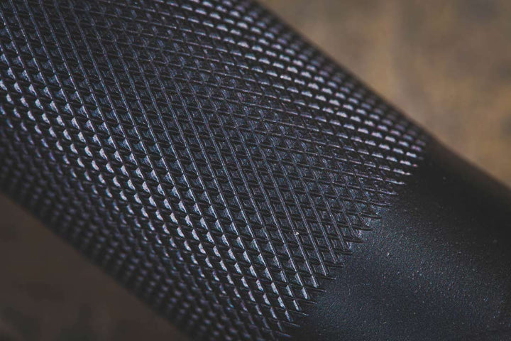 Close-up of the knurled grip on the StrongArm EZ Curl Bar, enhancing comfort for strength training and weightlifting.